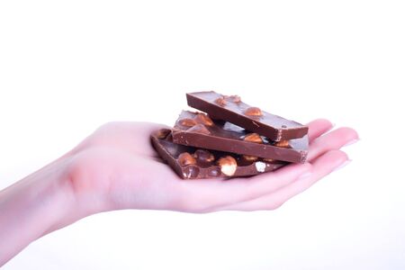 Chocolate with nuts on handの写真素材