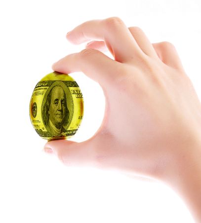Dollar in egg form in hand isolated on whiteの写真素材