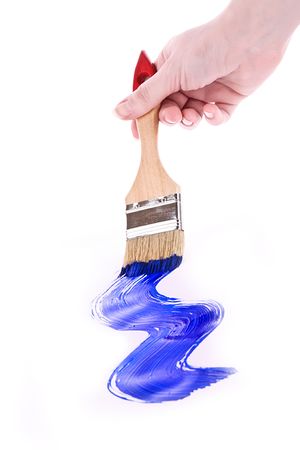 Hand with brush and blue paint isolated on whiteの写真素材
