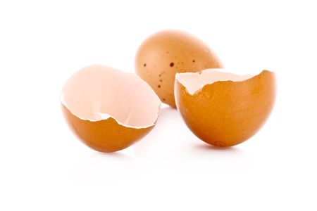 Broken egg isolated on whiteの写真素材
