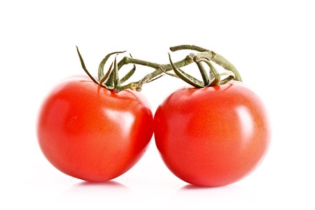 Two tomatos isolated on whiteの写真素材