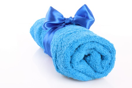 Twisted blue towel with band isolated on whiteの写真素材