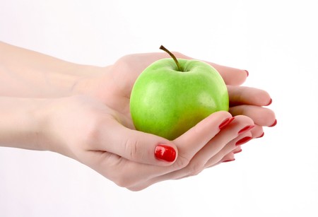 An apple on the hand isolated on whiteの写真素材