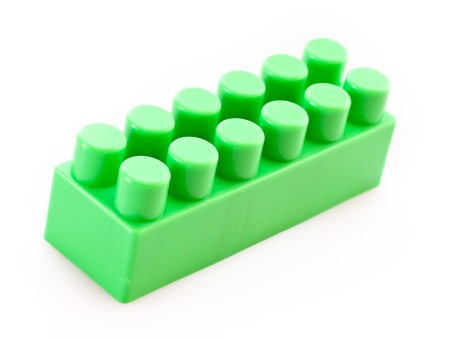 Green toy building brick isolated on white
