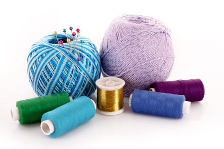 Wool ball and thread bobbin isolated on white