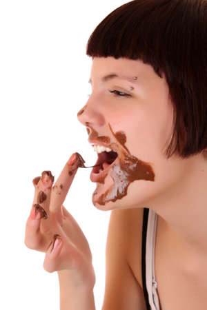 Young beautiful glutton eat chocolate isolated on whiteの写真素材
