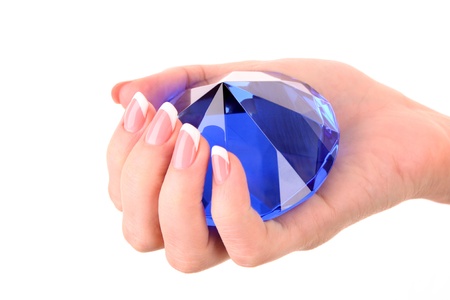 Giant blue diamond in hand isolated on whiteの写真素材