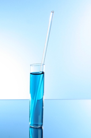 Test tube on blue background. With glass stickの写真素材