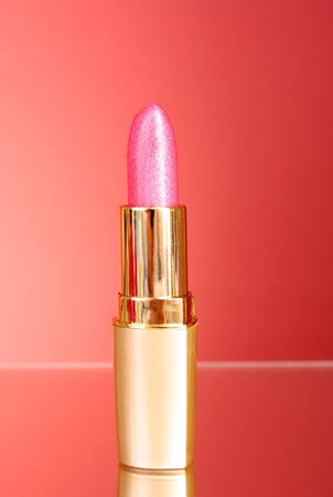 Lipstick isolated on red backgroundの写真素材