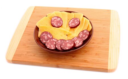 Sausage and cheese in smile form on plateの写真素材