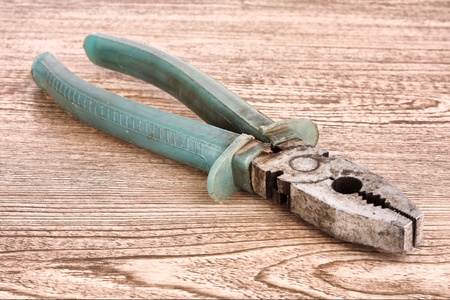 Pliers on wooden surfaceの写真素材