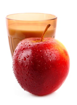 Glass with milk and apple isolated on whiteの写真素材