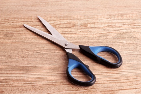 Scissors on wooden table