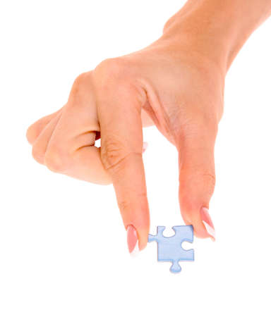 Hand with puzzle isolated on whiteの写真素材