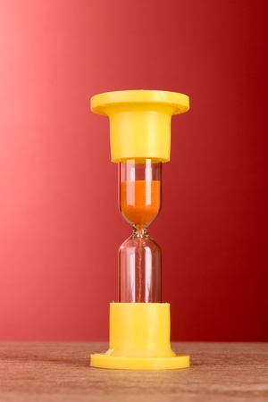 Yellow hourglass on red background