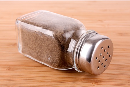 pepper shaker on wooden table