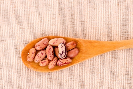 Beans in spoon on the fabric backgroundの写真素材