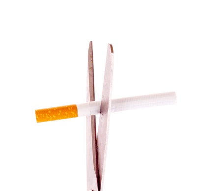 Scissors and cigarette isolated on whiteの写真素材