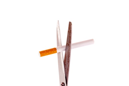 Scissors and cigarette isolated on whiteの写真素材