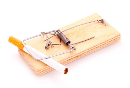 Cigarette in mousetrap isolated on whiteの写真素材