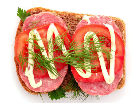 tomatoes and sausage on bread isolated on whiteの写真素材