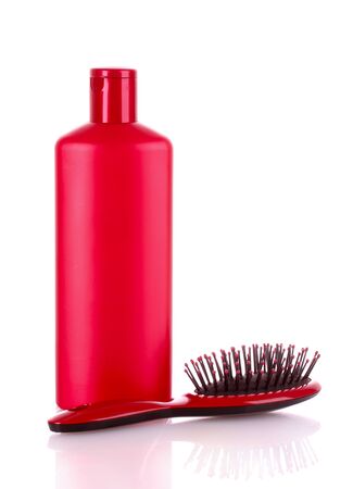 Shampoo bottles and hair brush on whiteの写真素材