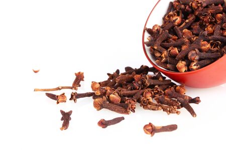 spice cloves in a bowl isolated on whiteの写真素材