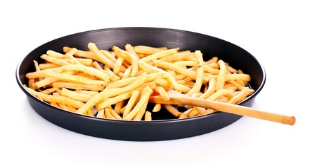 French fries in the pan isolated on white