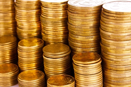 Many coins in columns isolated on white. Ukrainian coins