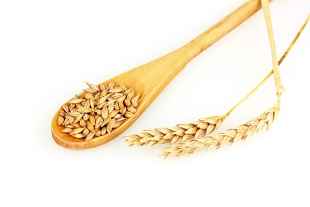 Wheat in spoon  isolated on whiteの写真素材