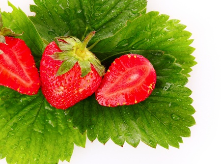strawberry with green leaves isolated on whiteの写真素材
