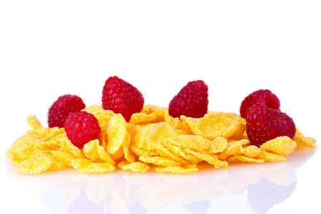 tasty cornflakes and raspberries isolated on whiteの写真素材