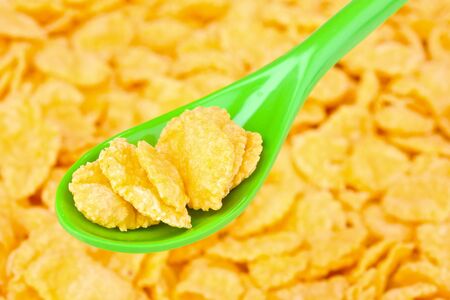 tasty cornflakes in green spoonの写真素材