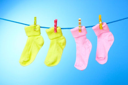 children's socks on a rope on a blue backgroundの写真素材