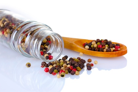 spice pepper in the glass and spoon isolated on whiteの写真素材