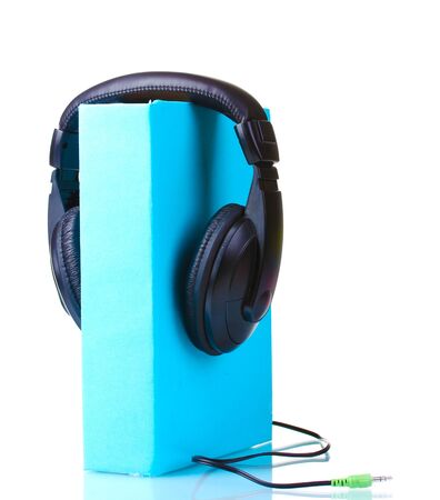 Headphones on book isolated on whiteの写真素材
