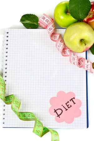 Planning of a diet. Notebook, pencil and fresh apples isolated on whiteの写真素材