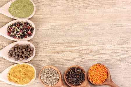 spices in the spoons on wooden backgroundの写真素材