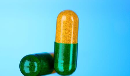 Medical capsules on blue backgroundの写真素材
