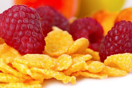 tasty cornflakes and fruit isolated on whiteの写真素材