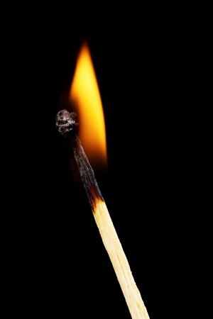 Burning match on black backgroundの写真素材