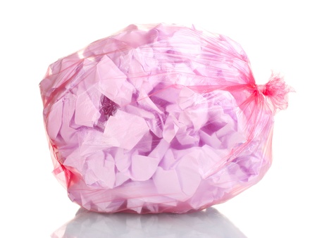 red garbage bag with trash isolated on whiteの写真素材