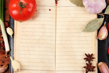 notebook for recipes and spices on wooden tableの写真素材