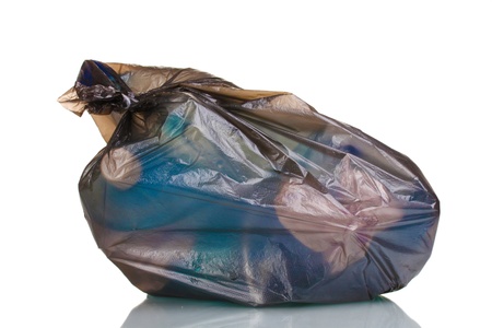 black garbage bag with trash isolated on whiteの写真素材