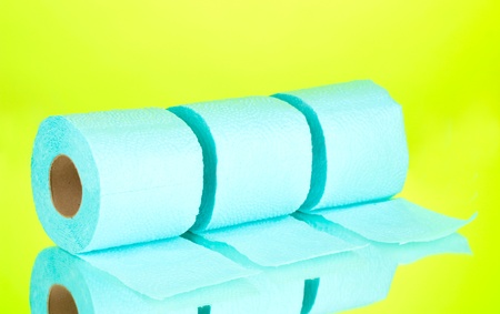 blue rolls of toilet paper on green backgroundの写真素材