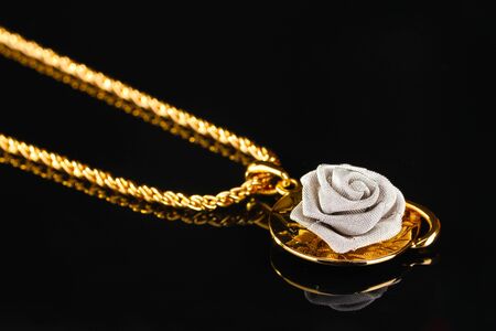 Pendant in form of rose on blackの写真素材