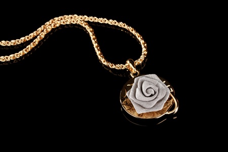 Pendant in form of rose on blackの写真素材