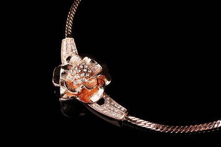 Pendant in form of flower on blackの写真素材