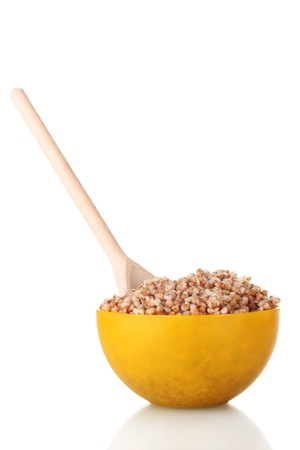 Boiled buckwheat in a yellow bowl isolated on whiteの写真素材