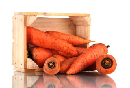 raw carrots in wooden box isolated on whiteの写真素材